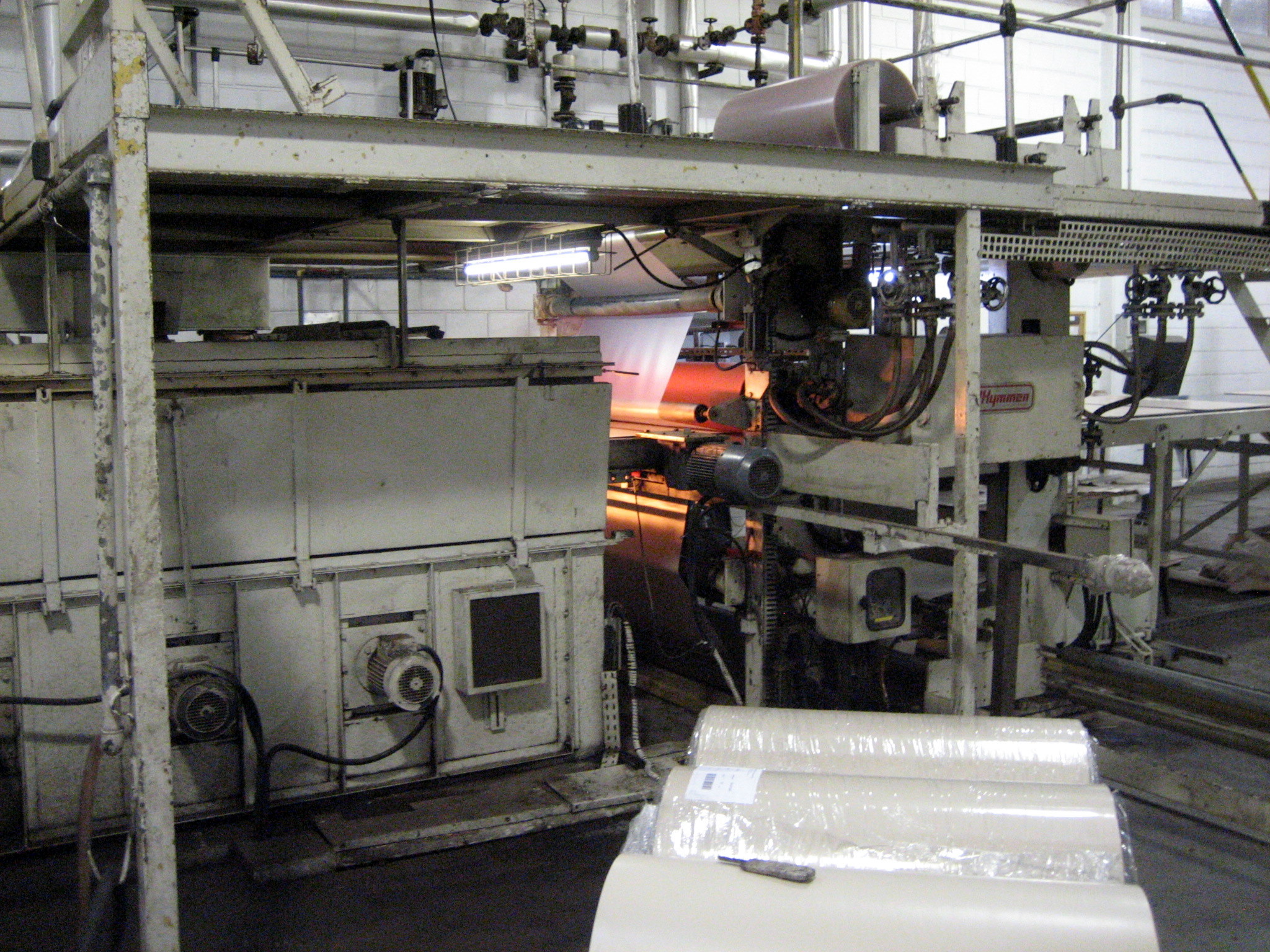 Industrial lamination press at a flooring manufacturing plant